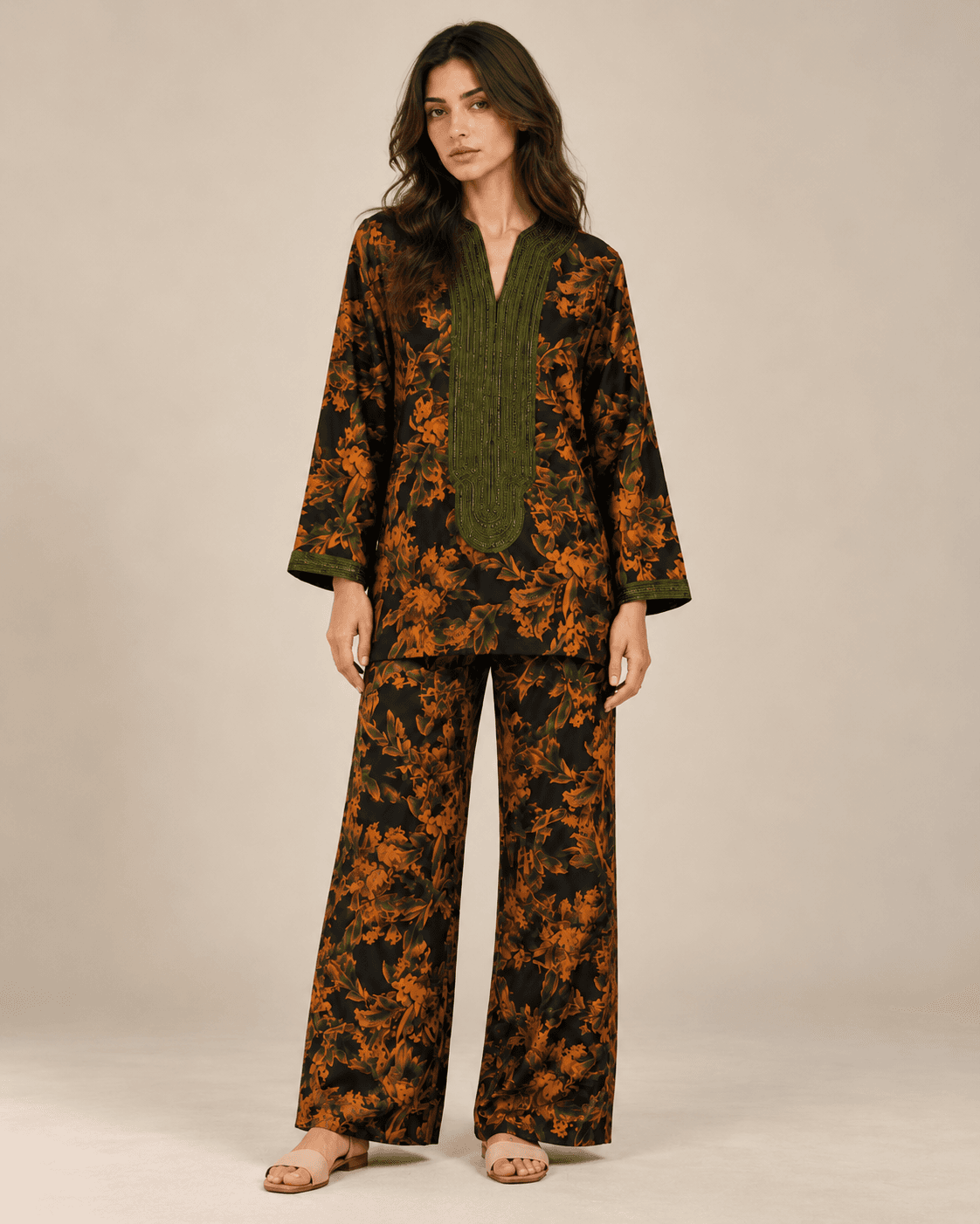 Fauve — A dark botanical ensemble in burnt orange, with olive-green embroidered detailing at the neckline and cuffs.