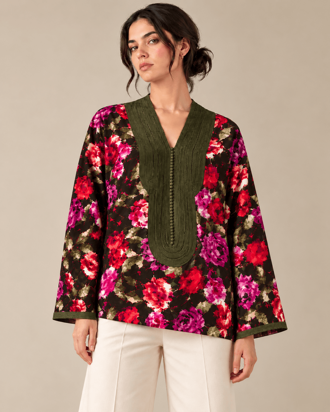 Vermeil — An oversized top with a dark floral print, featuring a textured olive-green panel at the neckline and matching cuffs.